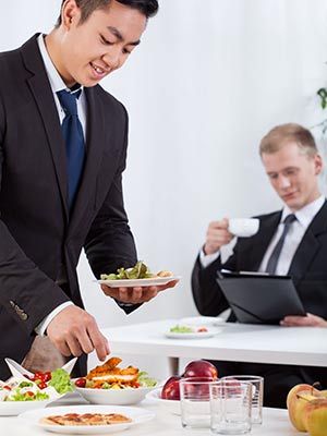 business people eating at work - corporate events
